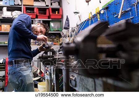 Stock Image - Fencing prop maker at work. Fotosearch