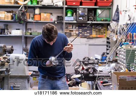 Stock Photograph - Fencing prop maker at work. Fotosearch
