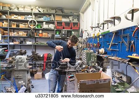 Stock Photography - Fencing prop maker at work. Fotosearch
