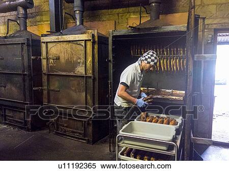 Stock Photography - Fish being prepared in smokehouse. Fotosearch