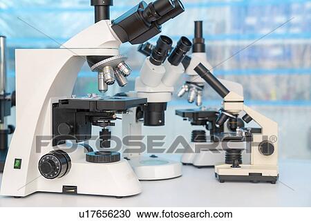 Stock Image - Four microscopes of different designs.. Fotosearch