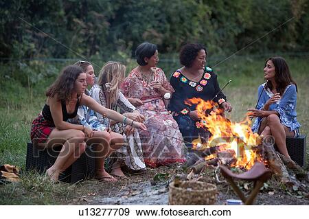 Stock Photo - Friends at bonfire party in park. Fotosearch
