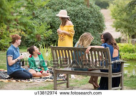 Picture - Friends at picnic party in park. Fotosearch