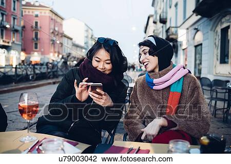 Friends enjoying drink at outdoor cafe, Milan, Italy View Large Photo Image Stock Image - Friends enjoying drink at outdoor cafe, Milan, Italy. Fotosearch