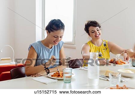 Friends enjoying lunch at home View Large Photo Image Stock Photography - Friends enjoying lunch at home. Fotosearch