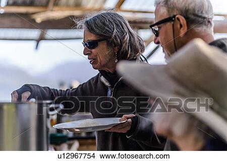 Picture - Friends having dinner outdoors. Fotosearch