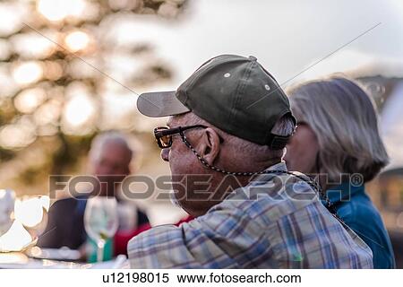 Friends having dinner outdoors View Large Photo Image Stock Photography - Friends having dinner outdoors. Fotosearch