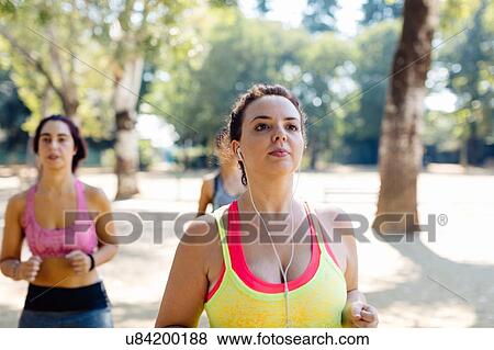 Stock Photo - Friends jogging in park. Fotosearch