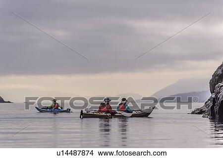 Picture - Friends kayaking in lake, Johnstone Strait, Telegraph Cove, Canada. Fotosearch