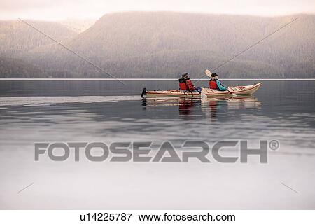 Stock Photo - Friends kayaking in lake, Johnstone Strait, Telegraph Cove, Canada. Fotosearch