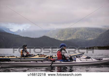 Friends kayaking in lake, Johnstone Strait, Telegraph Cove, Canada View Large Photo Image Stock Photo - Friends kayaking in lake, Johnstone Strait, Telegraph Cove, Canada. Fotosearch