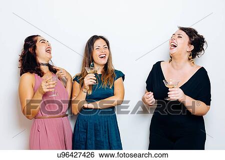 Friends laughing and celebrating with drinks View Large Photo Image Stock Photograph - Friends laughing and celebrating with drinks. Fotosearch