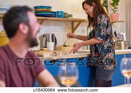 Picture - Friends laughing at dinner party. Fotosearch