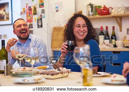 Friends laughing at dinner party View Large Photo Image Stock Image - Friends laughing at dinner party. Fotosearch