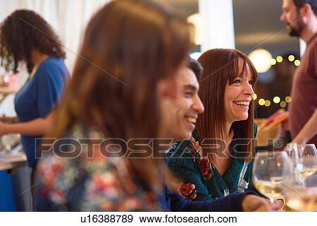 Friends laughing at dinner party View Large Photo Image Stock Photo - Friends laughing at dinner party. Fotosearch