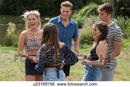Friends laughing in park View Large Photo Image Stock Photograph - Friends laughing in park. Fotosearch