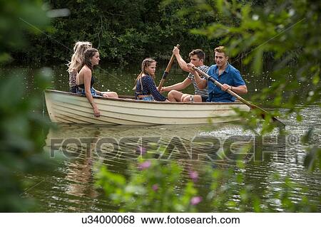 Stock Photo - Friends on boat ride in lake. Fotosearch