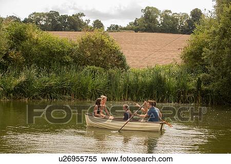 Stock Photography - Friends on boat ride in lake. Fotosearch