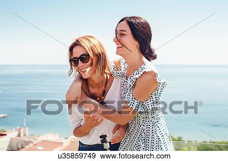 Stock Photo - Friends on seaside terrace, Odessa, Ukraine. Fotosearch