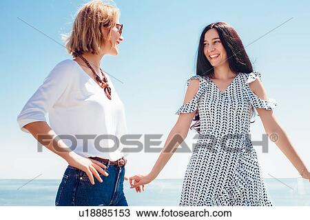 Friends on seaside terrace View Large Photo Image Stock Image - Friends on seaside terrace. Fotosearch
