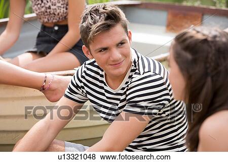 Friends relaxing in park View Large Photo Image Stock Photo - Friends relaxing in park. Fotosearch
