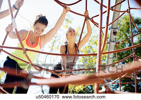 Friends rope climbing in park View Large Photo Image Stock Image - Friends rope climbing in park. Fotosearch