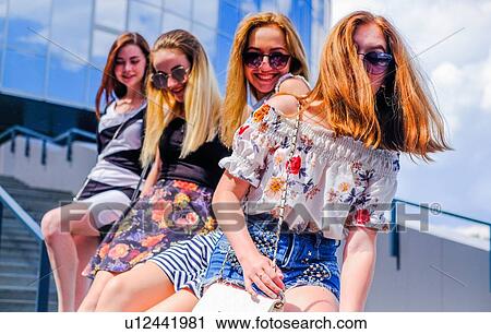 Friends sitting on staircase View Large Photo Image Stock Image - Friends sitting on staircase. Fotosearch