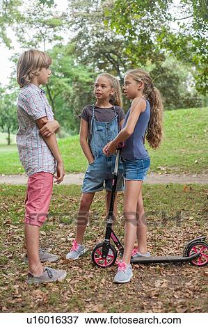 Stock Photo - Friends talking in park. Fotosearch