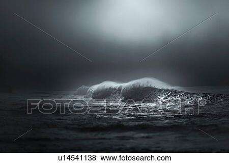 Stock Photo - Giant waves breaking in the mist lighted by sun, Lahinch, Clare, Ireland. Fotosearch