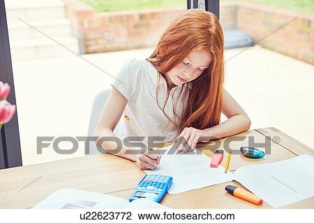 Stock Image - Girl doing homework. Fotosearch