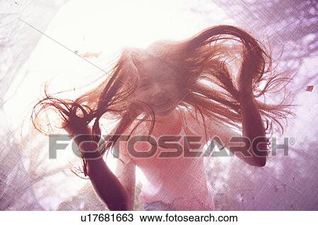 Girl peering through trampoline View Large Photo Image Stock Image - Girl peering through trampoline. Fotosearch