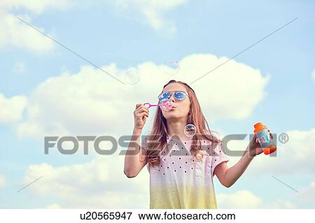 Girl playing with soap bubbles View Large Photo Image Stock Photo - Girl playing with soap bubbles. Fotosearch