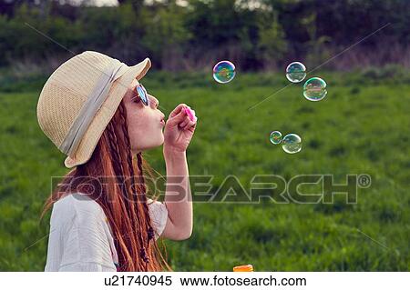 Girl playing with soap bubbles View Large Photo Image Stock Photography - Girl playing with soap bubbles. Fotosearch