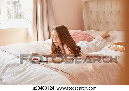 Girl reading book in bed View Large Photo Image Picture - Girl reading book in bed. Fotosearch