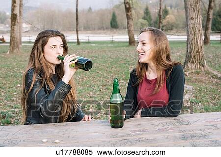 Girlfriends drinking beer in park View Large Photo Image Stock Photography - Girlfriends drinking beer in park. Fotosearch
