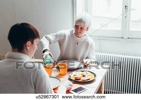 Girlfriends having lunch at home View Large Photo Image Stock Image - Girlfriends having lunch at home. Fotosearch