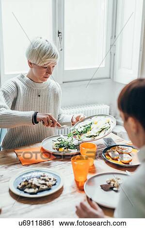 Girlfriends having lunch at home View Large Photo Image Stock Image - Girlfriends having lunch at home. Fotosearch