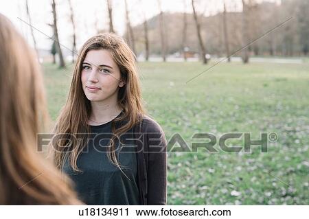 Stock Image - Girlfriends in park. Fotosearch