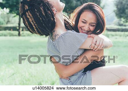 Picture - Girlfriends playing in park. Fotosearch