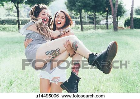 Stock Photograph - Girlfriends playing in park. Fotosearch