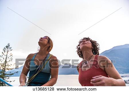 Stock Photo - Girlfriends preparing for rock climbing, Malamute, Squamish, Canada. Fotosearch