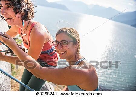 Stock Image - Girlfriends rock climbing, Malamute, Squamish, Canada. Fotosearch
