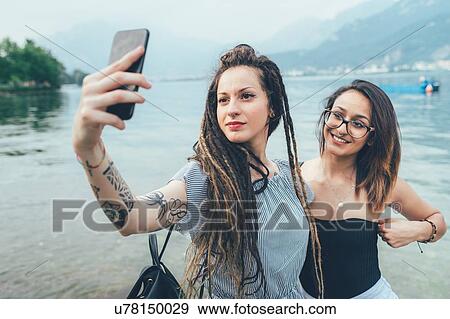 Girlfriends taking selfie by sea View Large Photo Image Stock Photo - Girlfriends taking selfie by sea. Fotosearch