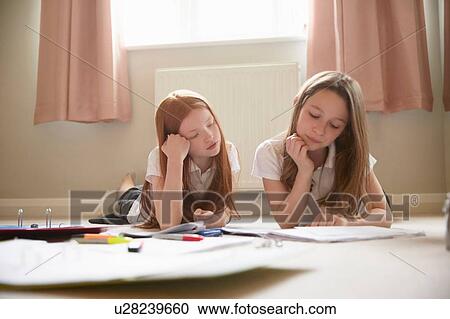 Stock Image - Girls doing homework. Fotosearch