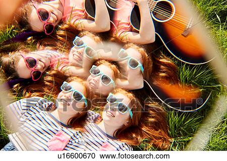 Girls playing guitar on grass View Large Photo Image Stock Image - Girls playing guitar on grass. Fotosearch