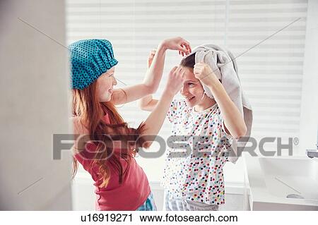 Stock Image - Girls playing in bathroom. Fotosearch