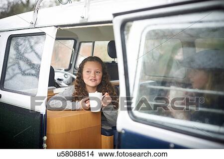 Girls with hot chocolate talking inside camper van View Large Photo Image Picture - Girls with hot chocolate talking inside camper van. Fotosearch