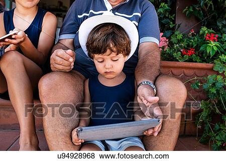 Grandfather sitting with grandsons on front door steps View Large Photo Image Stock Photo - Grandfather sitting with grandsons on front door steps. Fotosearch