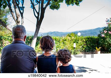 Grandfather sitting with grandsons outdoors View Large Photo Image Stock Image - Grandfather sitting with grandsons outdoors. Fotosearch