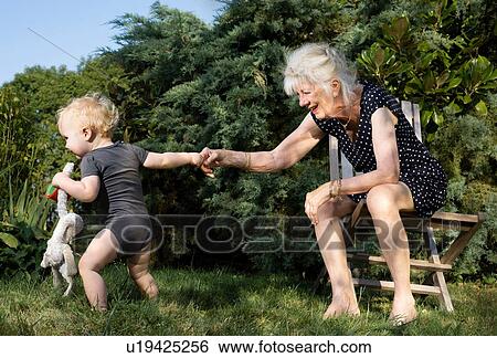 Grandmother and toddler in garden View Large Photo Image Stock Photograph - Grandmother and toddler in garden. Fotosearch